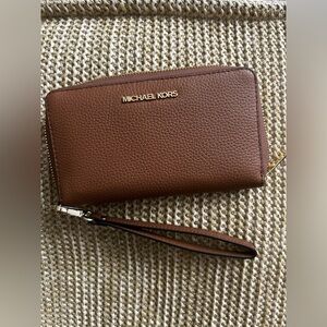 Michael Kors is wallet. New with tag.